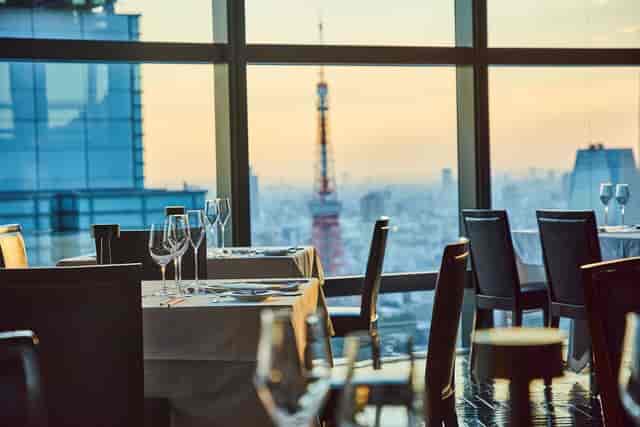 Private dining room at Fish Bank TOKYO with sunset skyline view for corporate gala or board dinner.