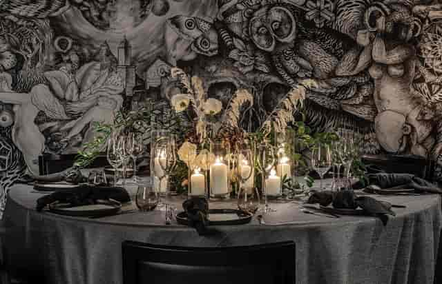 Elegant round table with candles at Masha Hari Theatre for upscale events.