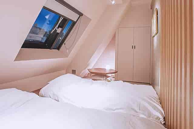 Kutani hotel room in Asakusa Kaede with low attic ceilings for budget travel and event lodging.