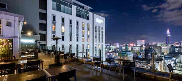 Rooftop networking reception at Restaurant G Shinjuku with modern skyline views.