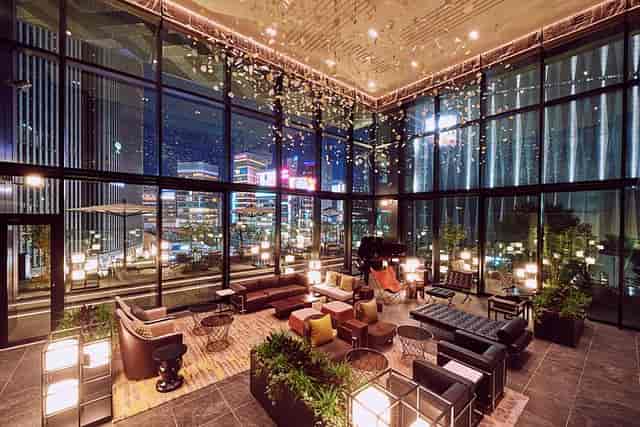 VIP lounge at THE GATE HOTEL with floor-to-ceiling city views for upscale corporate events.