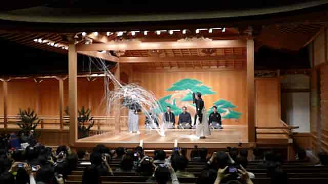 Kanze Noh Theatre GINZA SIX performance with dramatic lighting, Japanese cultural event.