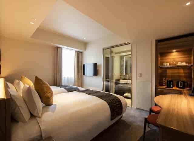 Modern twin hotel room at karaksa hotel premier Tokyo Ginza for corporate business travel events.