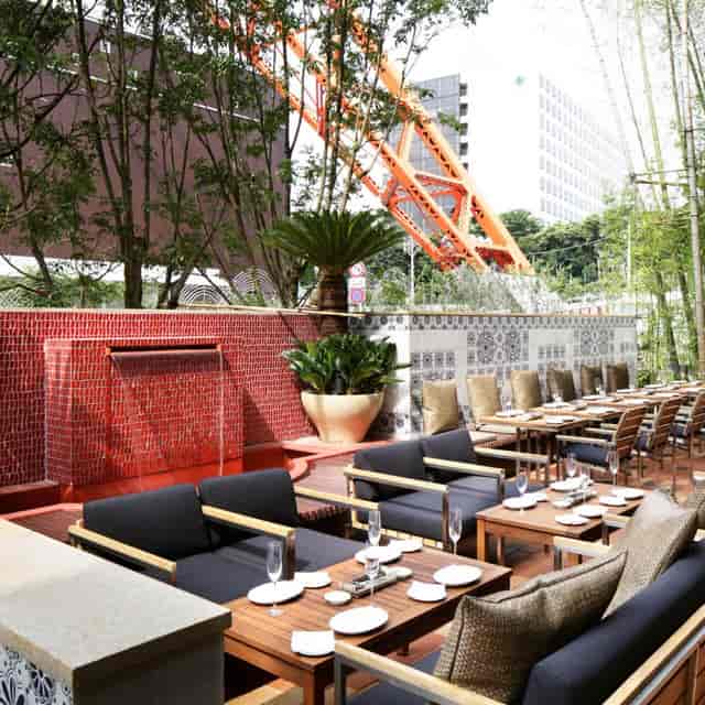 Rooftop garden terrace with red water feature for cocktail receptions and networking events.