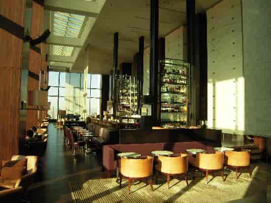 Sophisticated sky lounge with elegant decor for upscale corporate networking and VIP events.