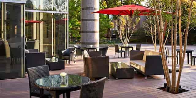 Outdoor cocktail lounge with high-top seating for professional networking and event receptions.