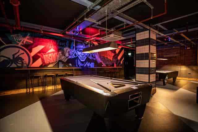 The Gaming Hall at Roxy Lanes, featuring stylish pool tables for networking events.