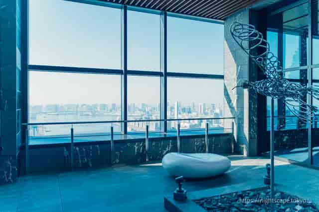 Modern lounge with sculptural art and panoramic views for networking and cocktail events.