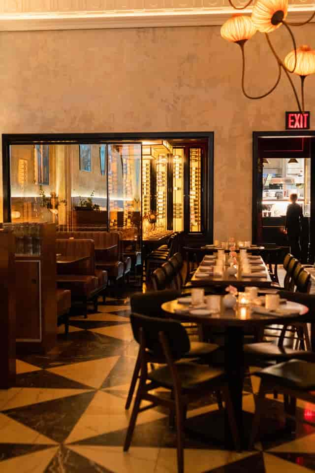 Private dining room at L'ADRESSE with wine-wall decor, ideal for executive dinners and events.
