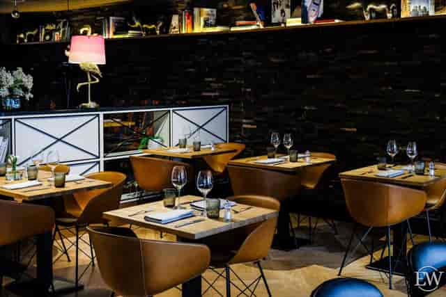 Upscale restaurant with warm lighting, ideal for corporate dinners and networking mixers.