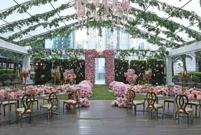 Luxury garden-party marquee in The Langham Ballroom with floral decor for weddings and events.