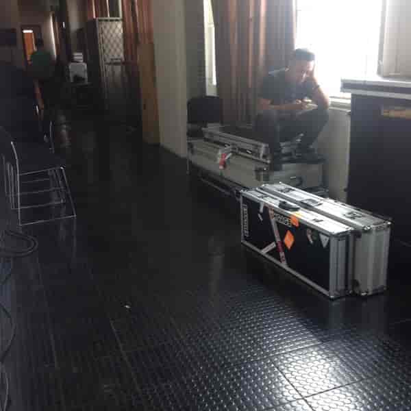 Technician resting in Upperroom Jakarta Annex Room 8 after event strike and gear load-out.