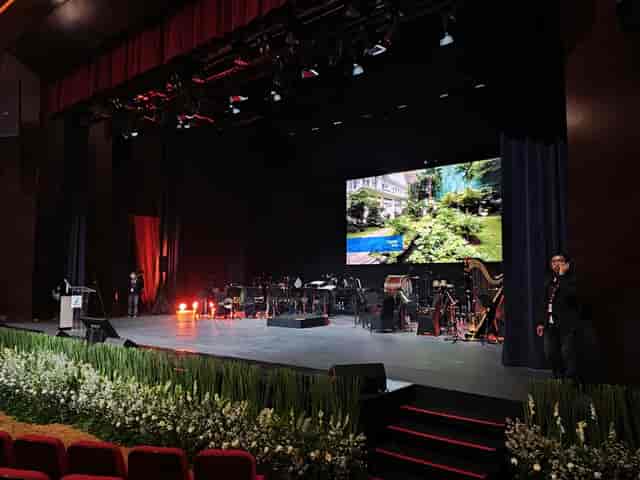 Ciputra Artpreneur stage with LED wall and floral décor for premium corporate event production.
