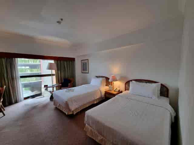 Twin hotel room at Sari Pacific Jakarta for business conference delegates.