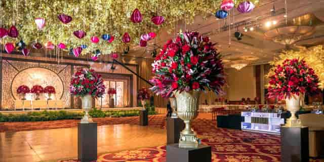Luxury Ritz-Carlton Jakarta ballroom with gold floral installation for wedding event production.