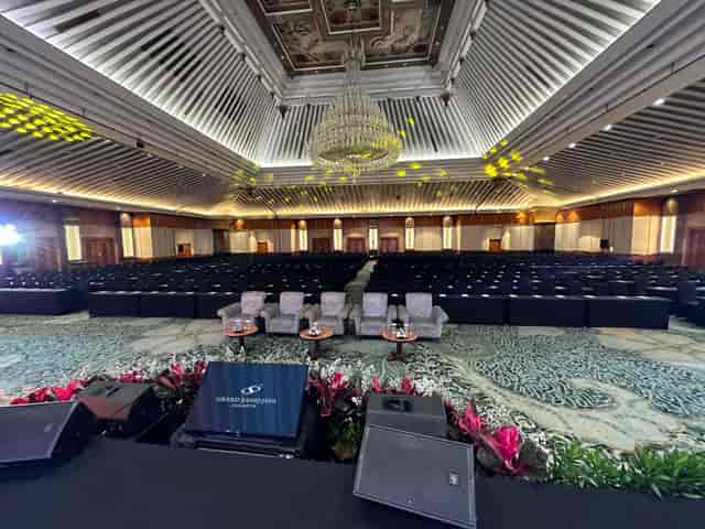 Grand Sahid Jaya Jakarta ballroom with stage and classroom seating for conferences and events.