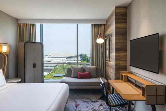 Swissotel Jakarta PIK Avenue premium guest room with workspace for corporate business travel.