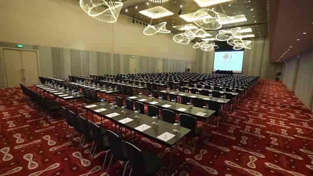 Classroom-style meeting room with modern light fixtures at DoubleTree Jakarta for corporate events.