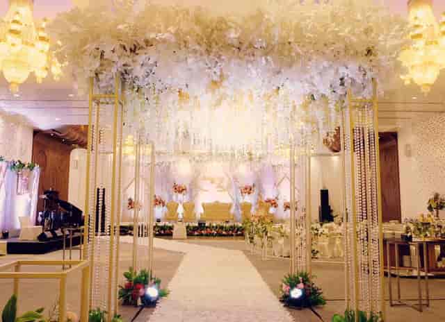 Luxury ballroom with floral ceiling installation for a wedding or gala event.