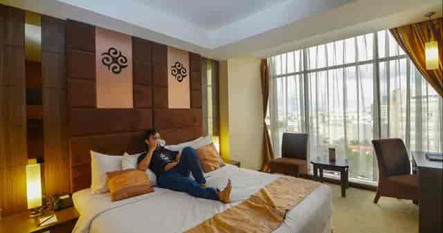 Grand Tjokro Jakarta premium hotel suite with floor-to-ceiling windows for executive travel.
