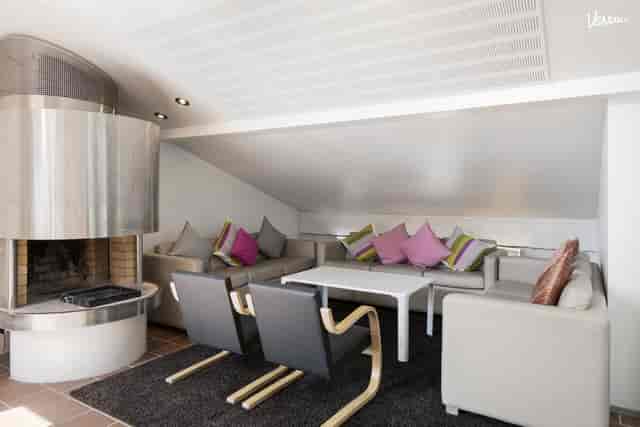 Cozy Radisson Blu Aleksanteri lounge with fireplace for corporate meetings and VIP networking.