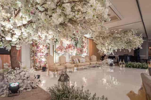Luxury wedding floral installation on ballroom dance floor for enchanted garden gala staging.