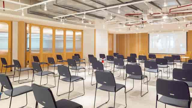 Theater-style event space with industrial design for corporate workshops and presentations.