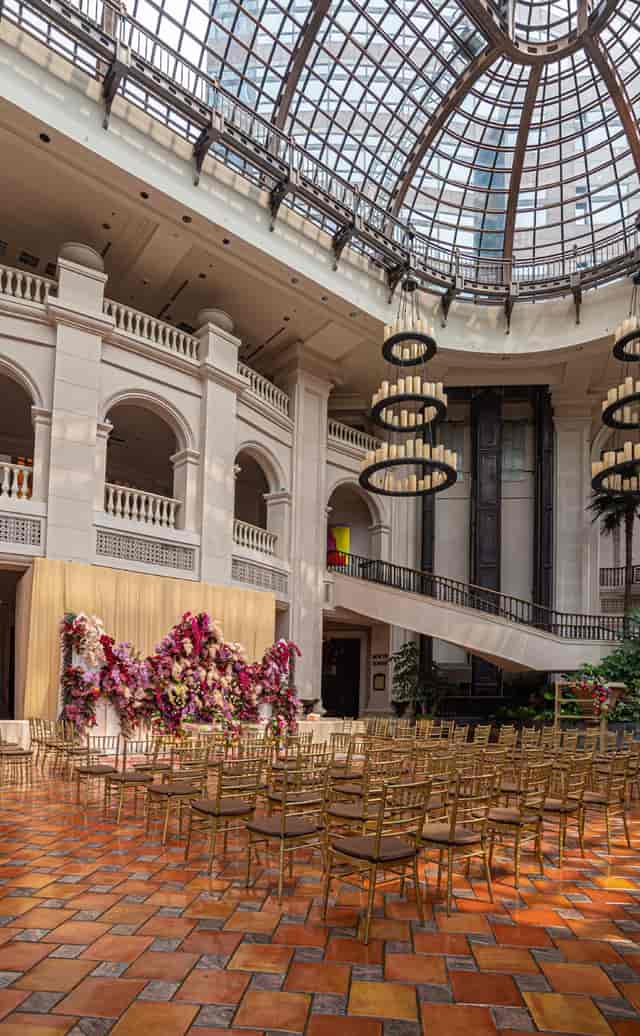 Luxury gala ballroom at Sampoerna Strategic Square with grand tiered lighting and floral decor.