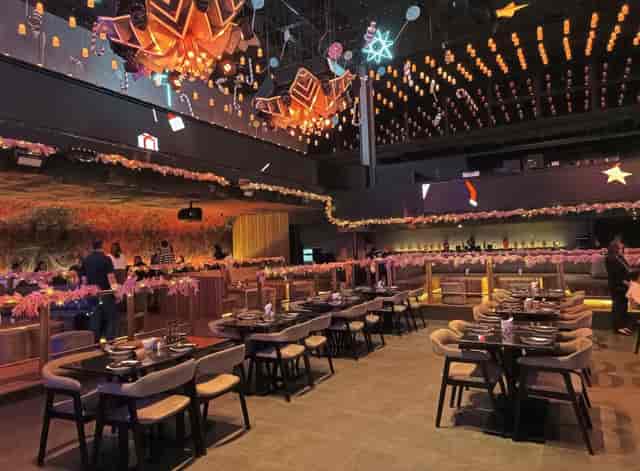 Upscale holiday event at Mantra Jakarta bar with festive decor and tiered banquet seating.