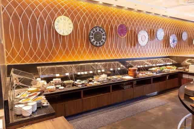 Modern hotel breakfast buffet with sneeze guards for conference catering.