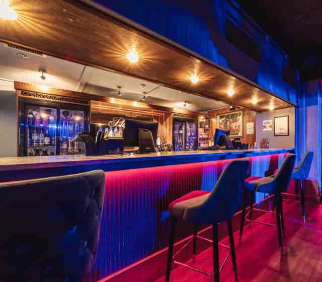 Playhouse venue with modern bar seating for VIP networking and corporate reception events.