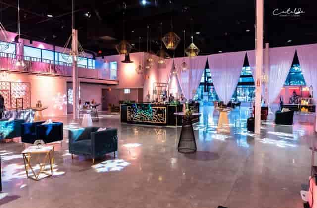 Industrial-chic Canvas Event Venue with velvet lounge seating for networking receptions.