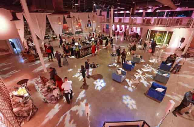 Modern event space with lounge seating and snowflake lighting for networking receptions.