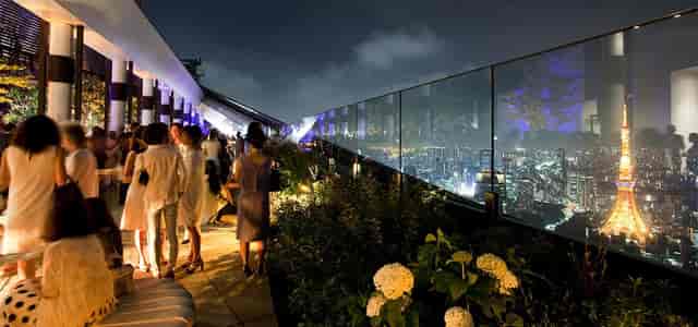 High-end evening reception at Andaz Tokyo rooftop with city skyline views for corporate events.