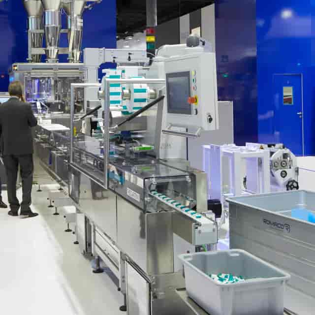 B2B industrial booth in Hall 5.0 at ACHEMA with professional machinery demonstration.