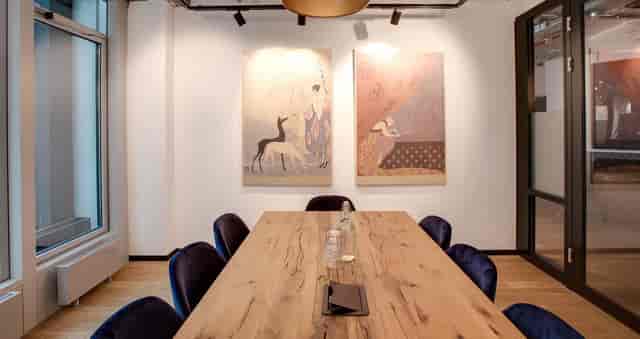 Modern boardroom with wood table for executive meetings and corporate strategy sessions.