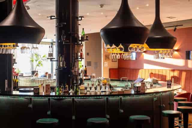 Scandic Hotels bar lounge with high-top seating for professional networking and event receptions.