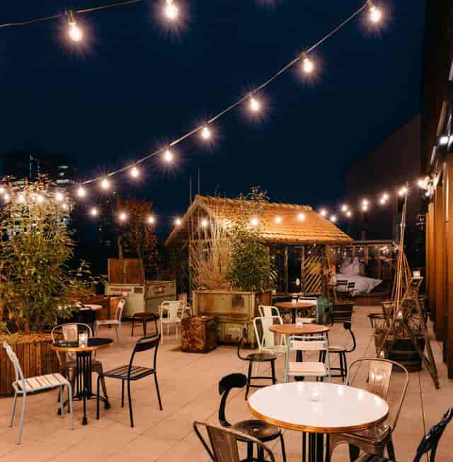 Rooftop terrace with bistro lighting, ideal for evening networking and corporate breakout events.