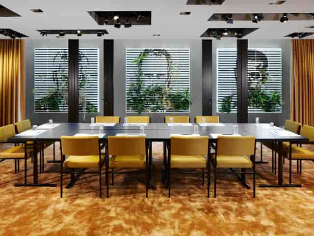Boardroom at 25hours Hotel The Goldman: luxury gold-toned interior for executive meetings.