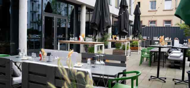Courtyard Terrace: Contemporary outdoor space with modular seating for corporate mixers.