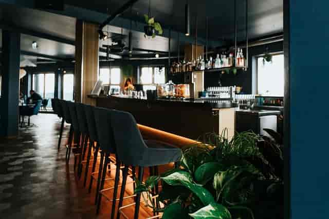 Sophisticated hotel rooftop bar with high-top seating for corporate networking and VIP events.