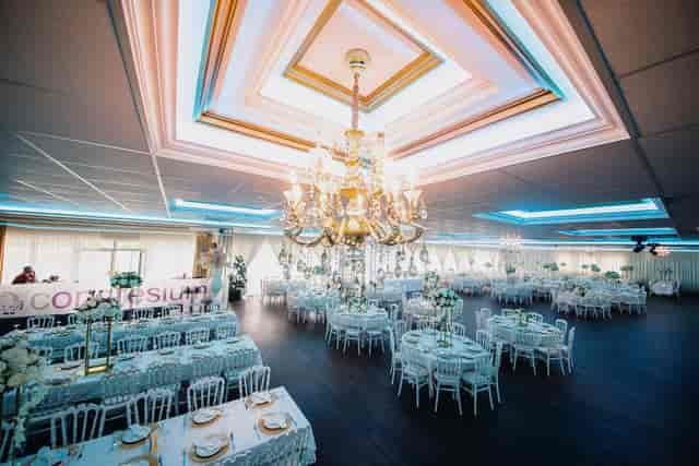 Congresium ballroom with crystal chandelier for formal wedding and gala event banquet.