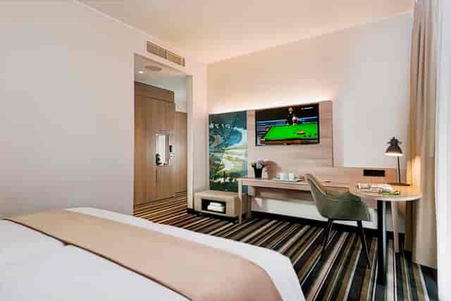 Modern hotel room with workspace in Darmstadt, ideal for business travel and corporate conferences.