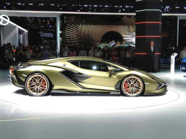 Automotive exhibit with rotating stage at trade show, professional event booth design.