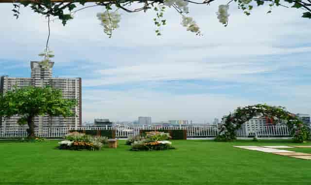 Rooftop Balai Sudirman venue with manicured lawn for outdoor weddings and corporate events.