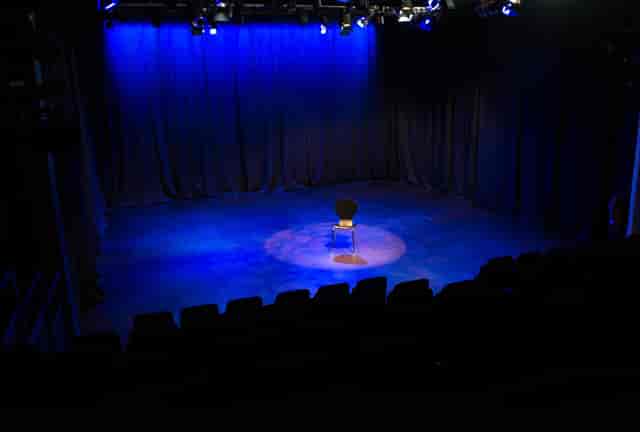 Brentwood Theatre auditorium, minimalist stage for keynote presentations and fireside chats.