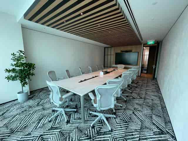 Modern boardroom with marble table for executive strategy and high-stakes client meetings.