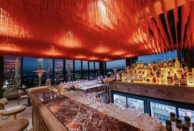 Jigger Kitchen & Bar: Red fringe ceiling at upscale corporate networking event and venue.