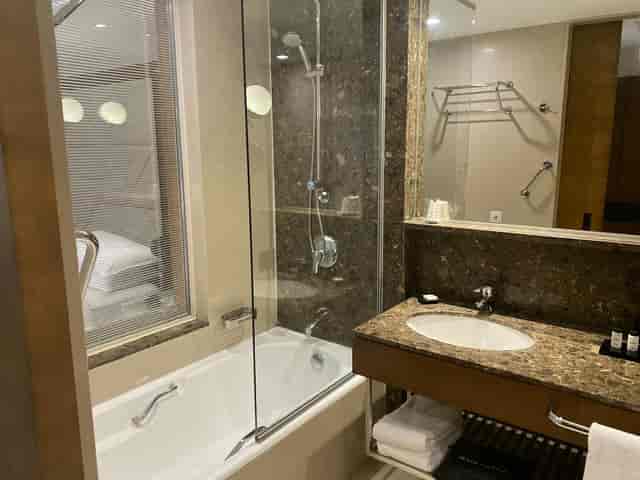 Marble hotel bathroom with glass shower in Sheraton Istanbul Levent for conference room blocks.