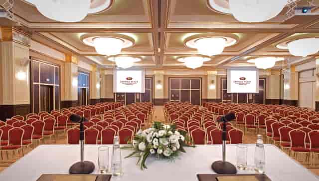 Theater-style conference ballroom with dual screens, ideal for corporate events and presentations.